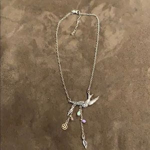 Silver colored bird necklace